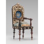 MODEL OF CLOCK-HOLDER ARMCHAIR, LATE 19TH CENTURY in ebony with finishes and inlays in ivory.