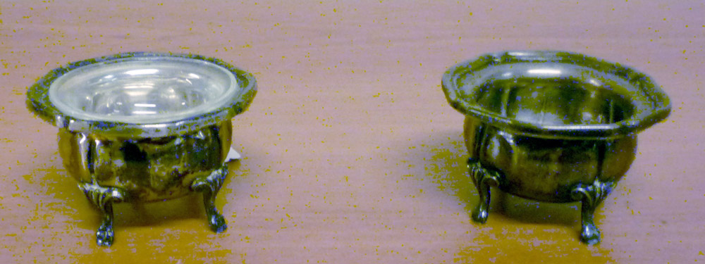 A PAIR OF SILVER SALT-BOWLS, EARLY 20TH CENTURY with leaves feet. One glass tub lacking. Measures