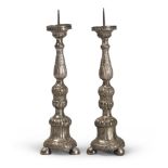 A PAIR OF SMALL SILVER CANDLESTICKS, LATE 18TH CENTURY embossed by leaves and pods with feet bell.