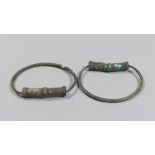 A PAIR OF LARGE ETRUSCAN BRONZE ARMILLS, 8TH-6TH CENTURY B.C. rod flat section ends with semi-