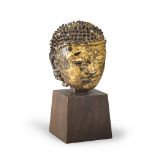 A THAI GILT AND LAQUERED STONE HEAD, 19TH CENTURY