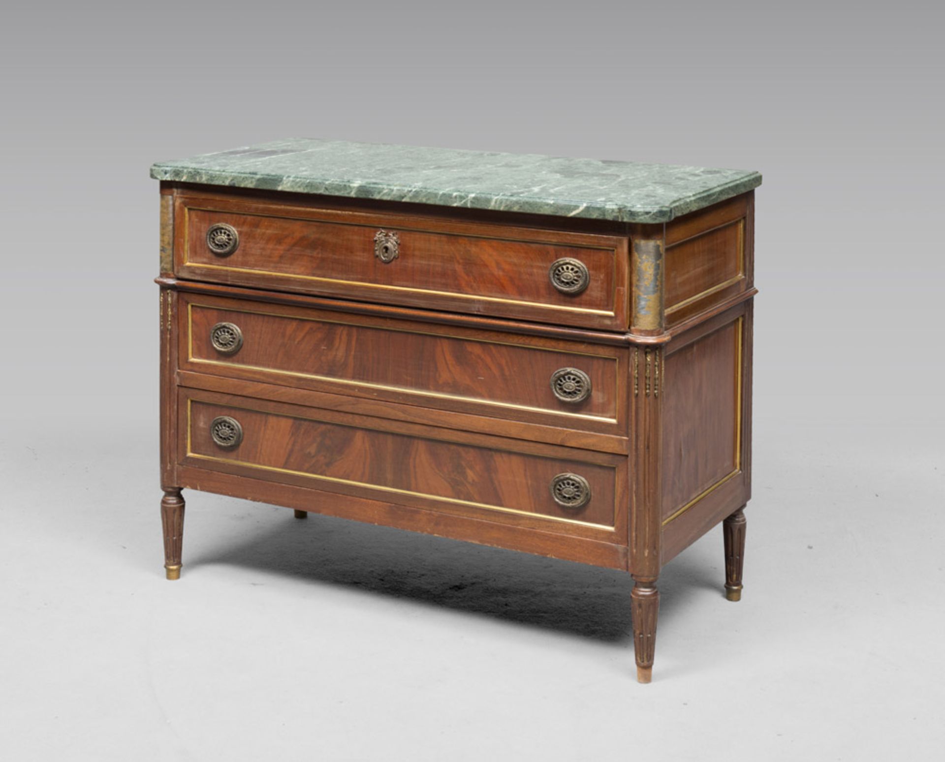 A SMALL MAHOGANY COMMODE, FRANCE LATE 18TH CENTURY With a green marble top and three drawer