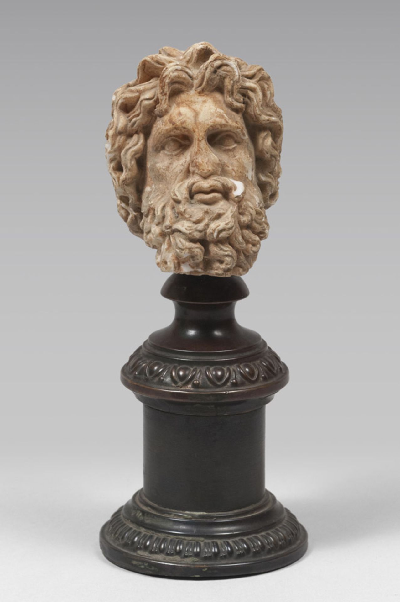 A SMALL CERAMIC HEAD, 20TH CENTURY representing classical head. Column sideburn in burnished