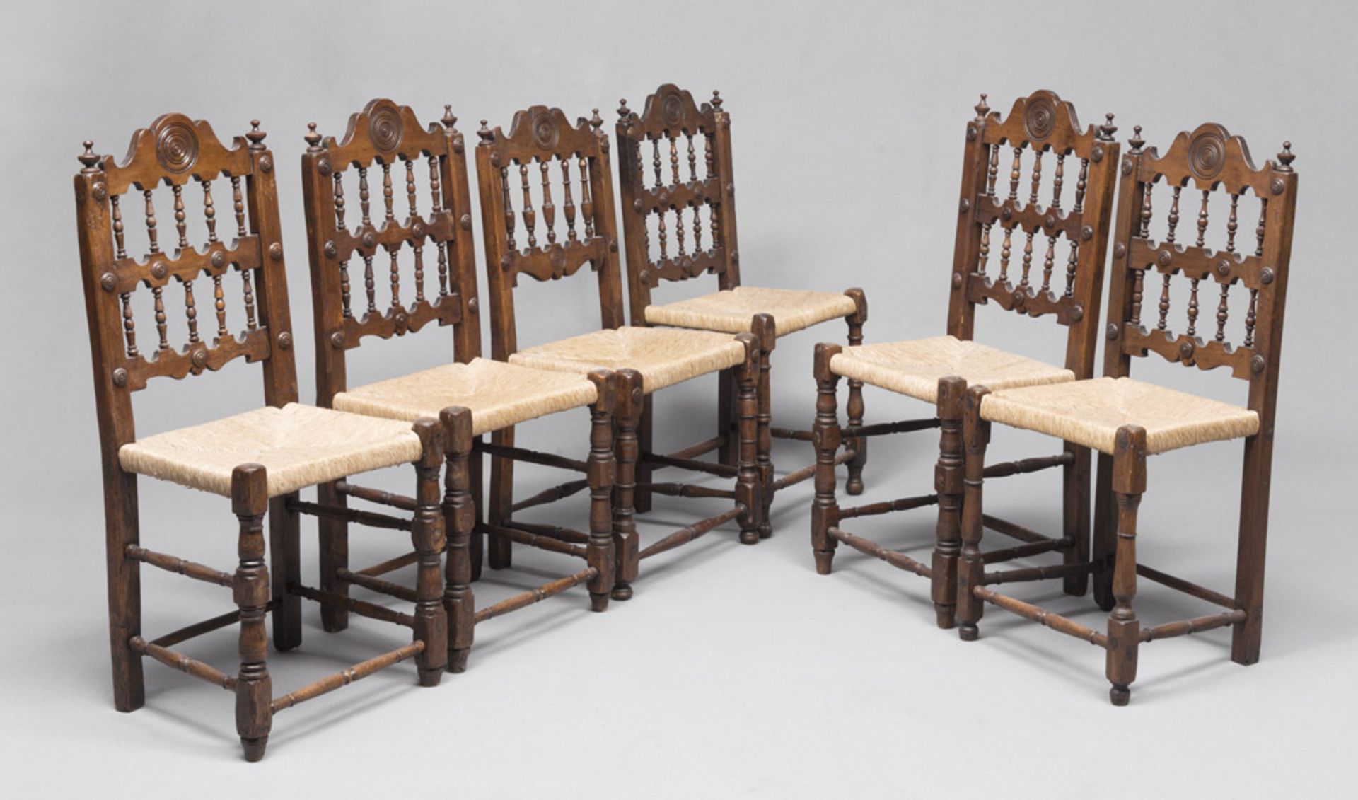 Six walnut-tree chairs with seats in straw, 19th century. Measures cm. 96 x 50 x 40.SEI SEDIE IN