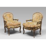 A pair of decolled wooden armchairs and velvet upholstery, probably Venice 18th century.