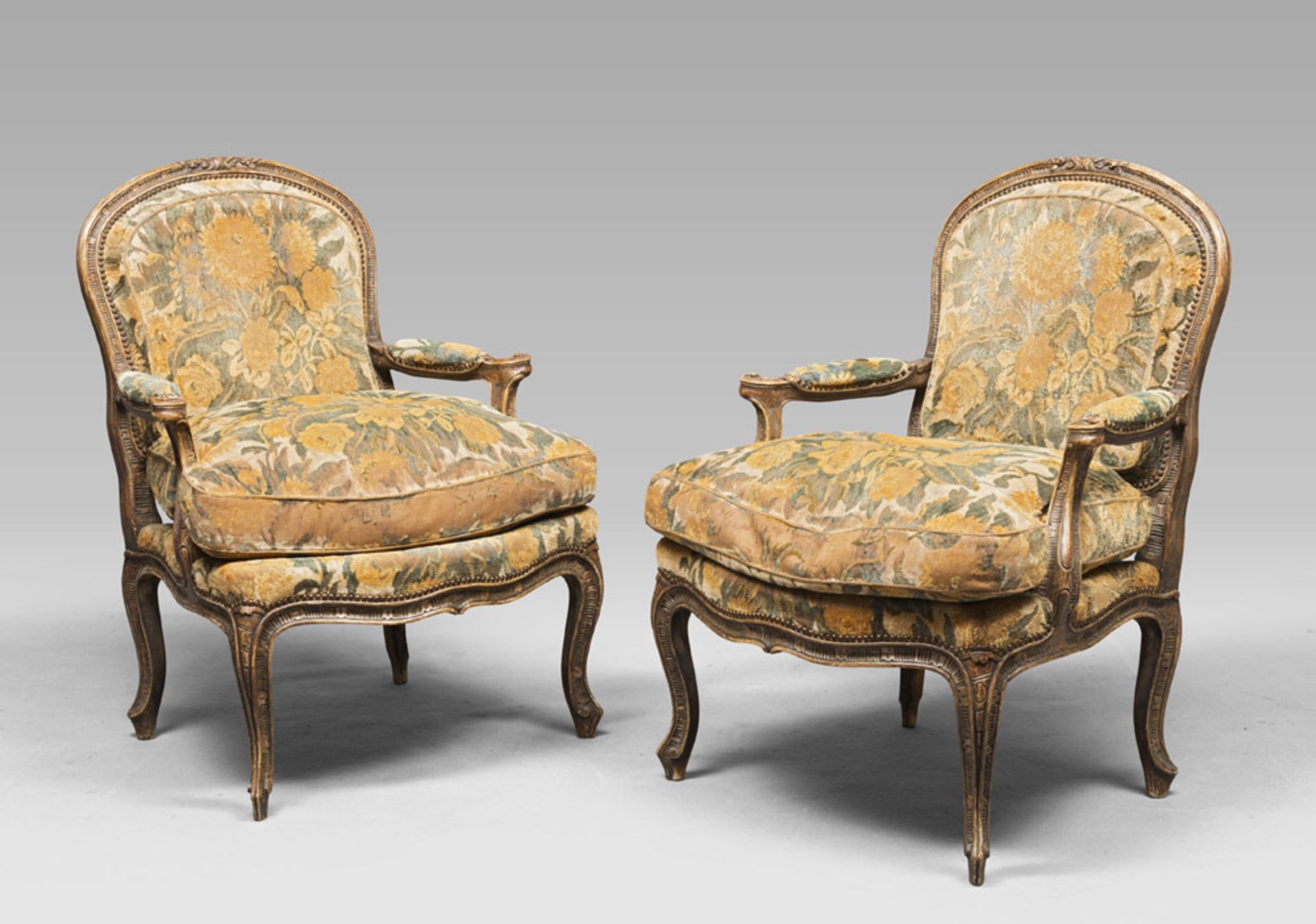 A pair of decolled wooden armchairs and velvet upholstery, probably Venice 18th century.