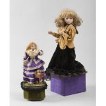 Two dolls made of wood carvings essence and ceramic cloth with clothes in cloth and satin, 20th