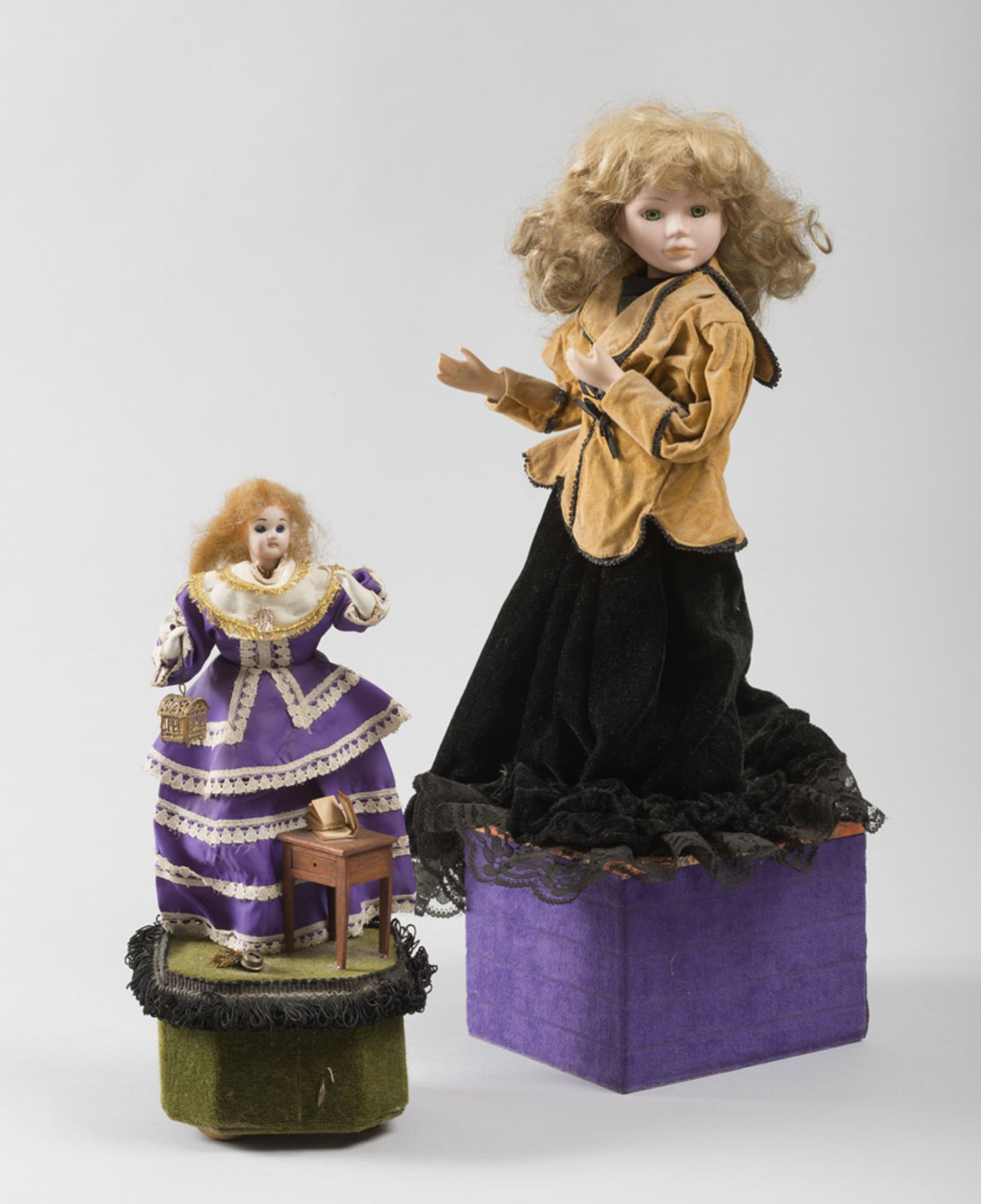 Two dolls made of wood carvings essence and ceramic cloth with clothes in cloth and satin, 20th