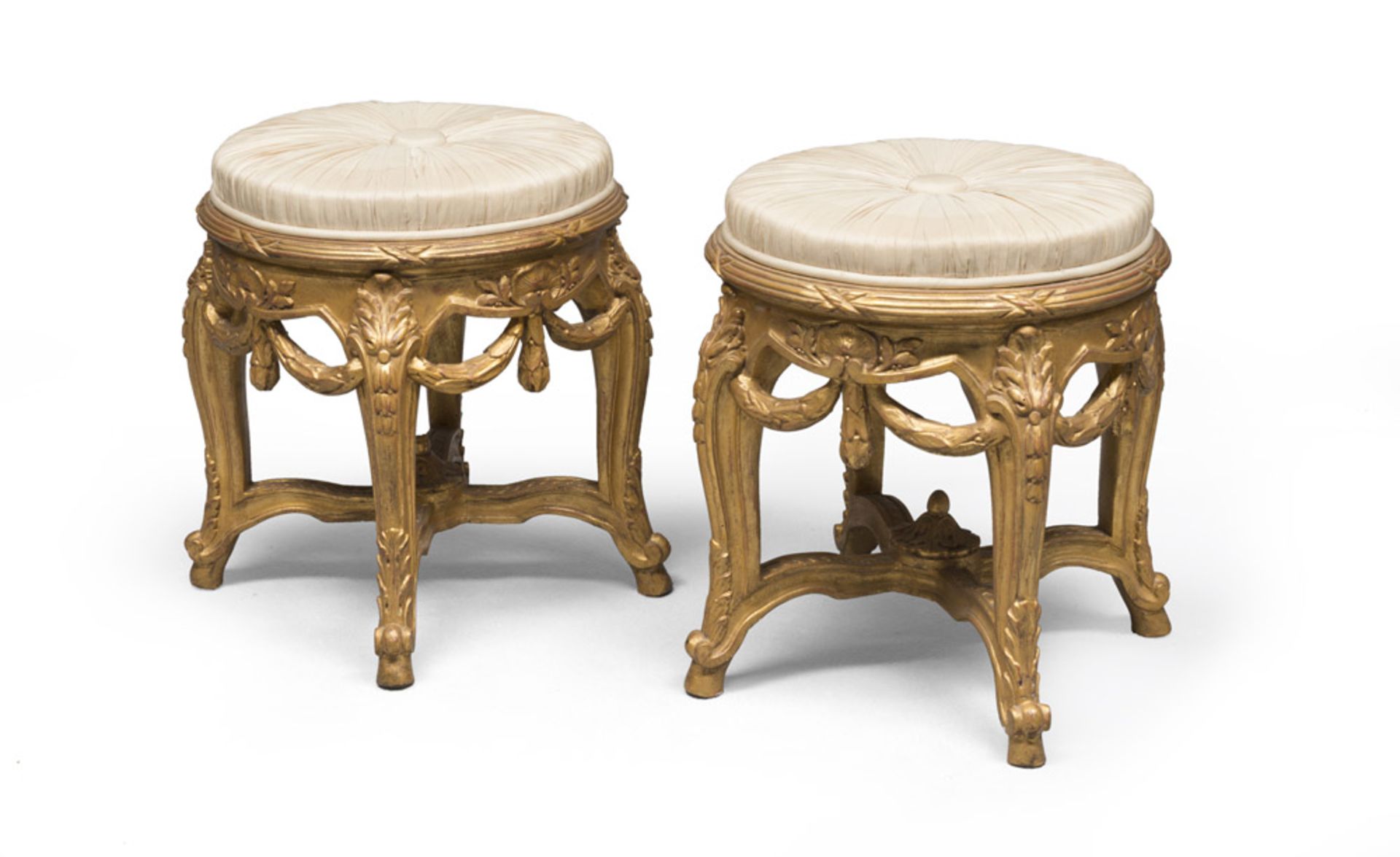 A pair of gilded wood stools with white satin seats, probably France 18th century. Measures cm. 55 x