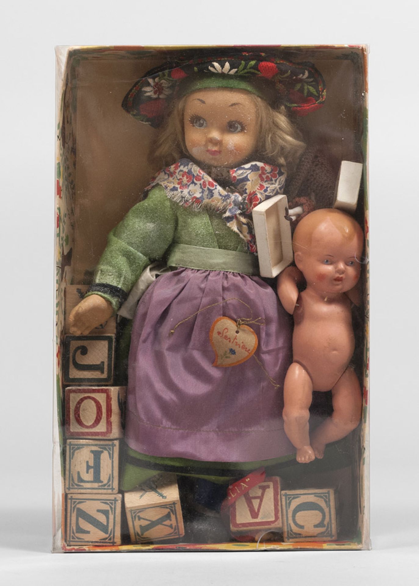 Doll, mid 20th century. Measures wrapping cm. 30 x 19 x 8.