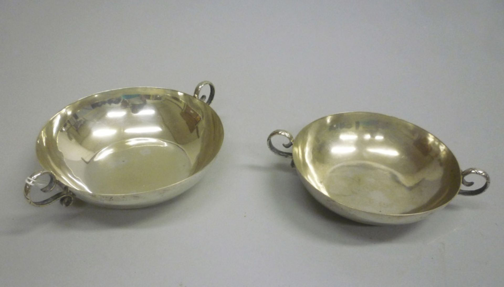 Two silver wine-tester, 20th century. Measures cm. 4 x 19 x 13,5 and cm. 3,5 x 16 x 12. General