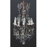 BRONZE CHANDELIER, EARLY 19TH CENTURY twelve molded arms, with glass pedestal base. Complete with