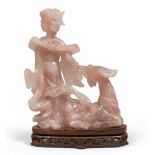 PINK QUARTZ SCULPTURE, CHINA EARLY 20TH CENTURY representing Guanyin with a fawn.