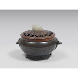 A Chinese bronze censer, with wood cover. 20th century. Measures cm. 12 x 15. INCENSIERE IN