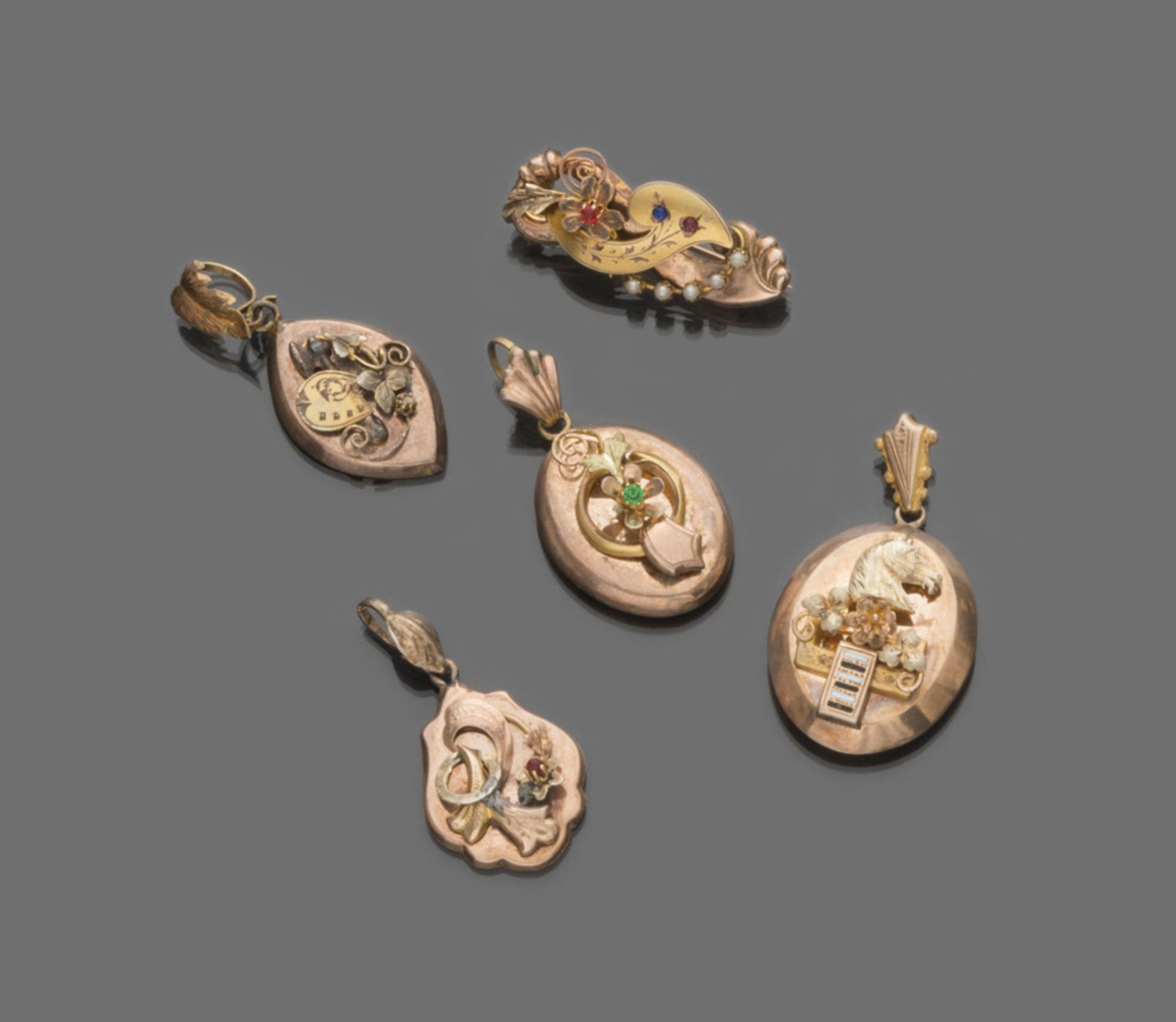 FOUR PENDANTS AND A BROOCH in low gold, with decorum of horse, shield and flowers