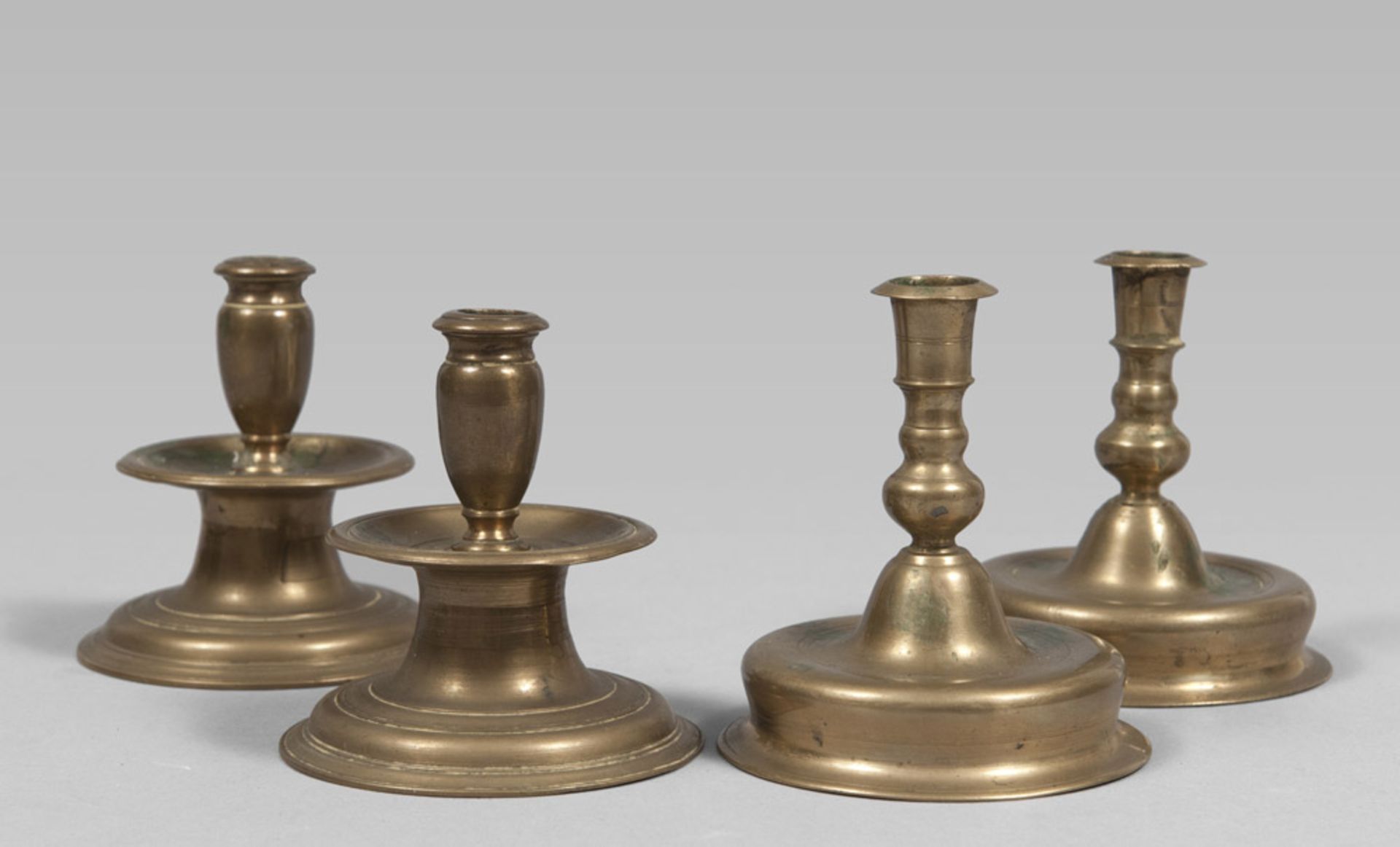 TWO PAIRS OF GILDED METAL CANDLESTICKS, 19TH CENTURY with snorkels and rounded bases and threaded.