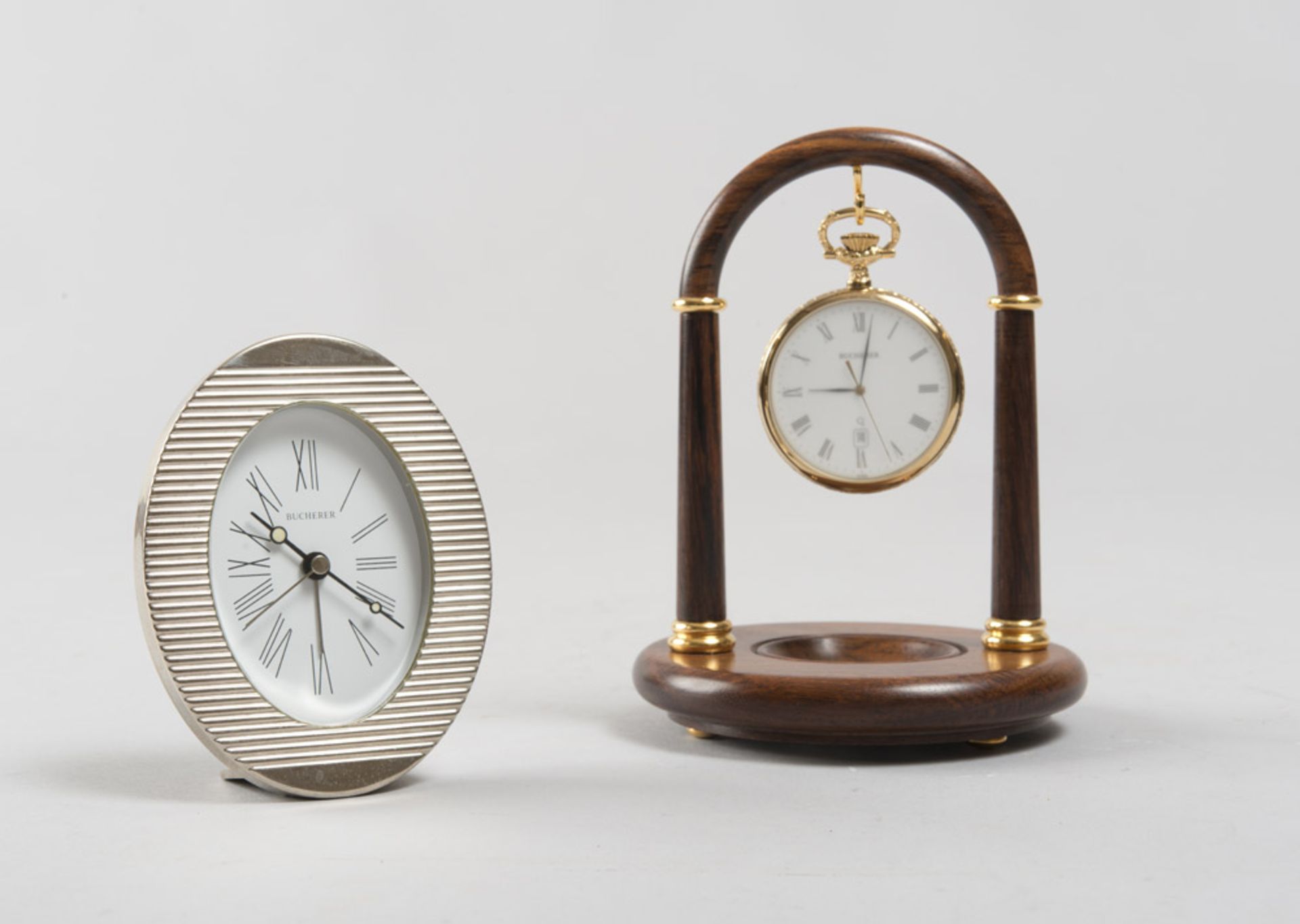 A TABLE CLOCK AND A POCKET WATCH, BRAND BUCHERER silver table clock with oval silver metal case