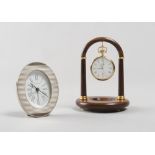 A TABLE CLOCK AND A POCKET WATCH, BRAND BUCHERER silver table clock with oval silver metal case