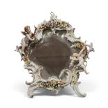 SMALL PORCELAIN MIRROR, EARLY 20TH CENTURY to enamels, with flowers frame, leaves and figures of