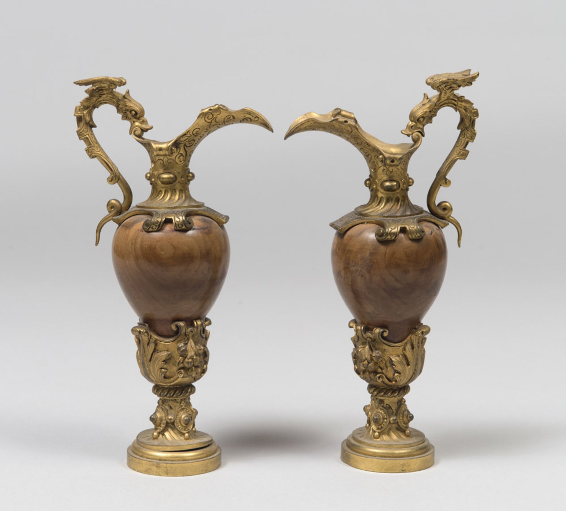 A PAIR OF SMALL WOOD AND BRONZE AMPHORAS, 19TH CENTURY with chisels to vegetable motives and handles