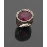 RING in white gold 18 kt., dome with faceted central ruby __and treated with pavè decorations of