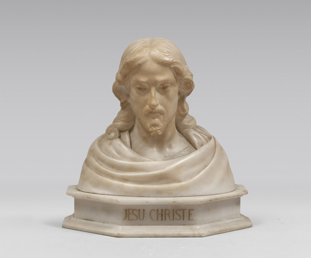 ALABASTER BUST, MID 20TH CENTURY depicting Christ's bust. Polygonal base titled to the front.