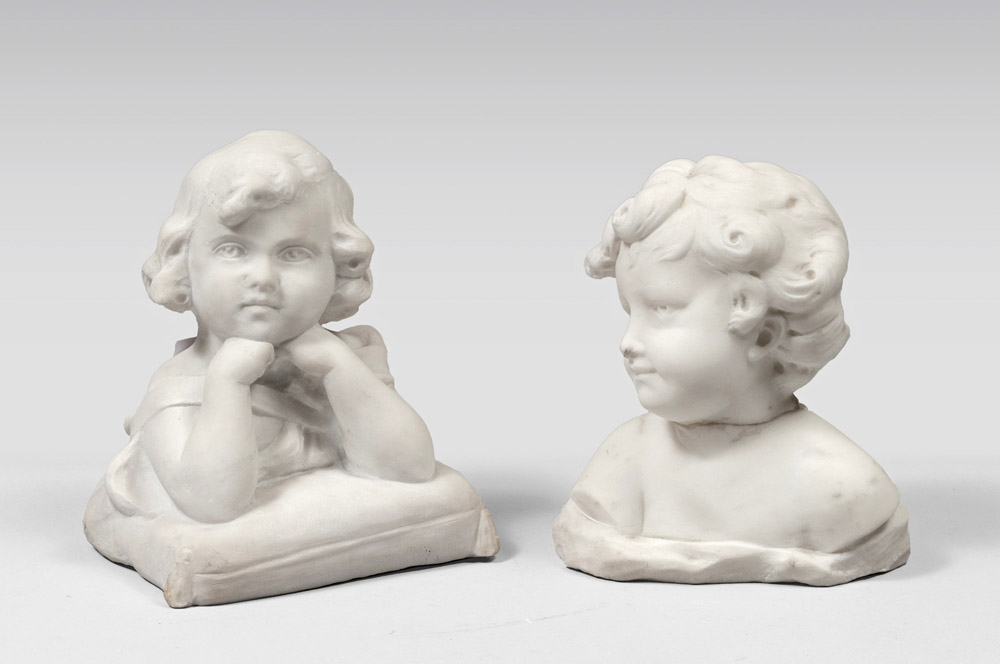 TWO WHITE MARBLE SCULPTURES OF CHILDREN, EARLY 20TH CENTURY one posing on a pillow. Measures cm.