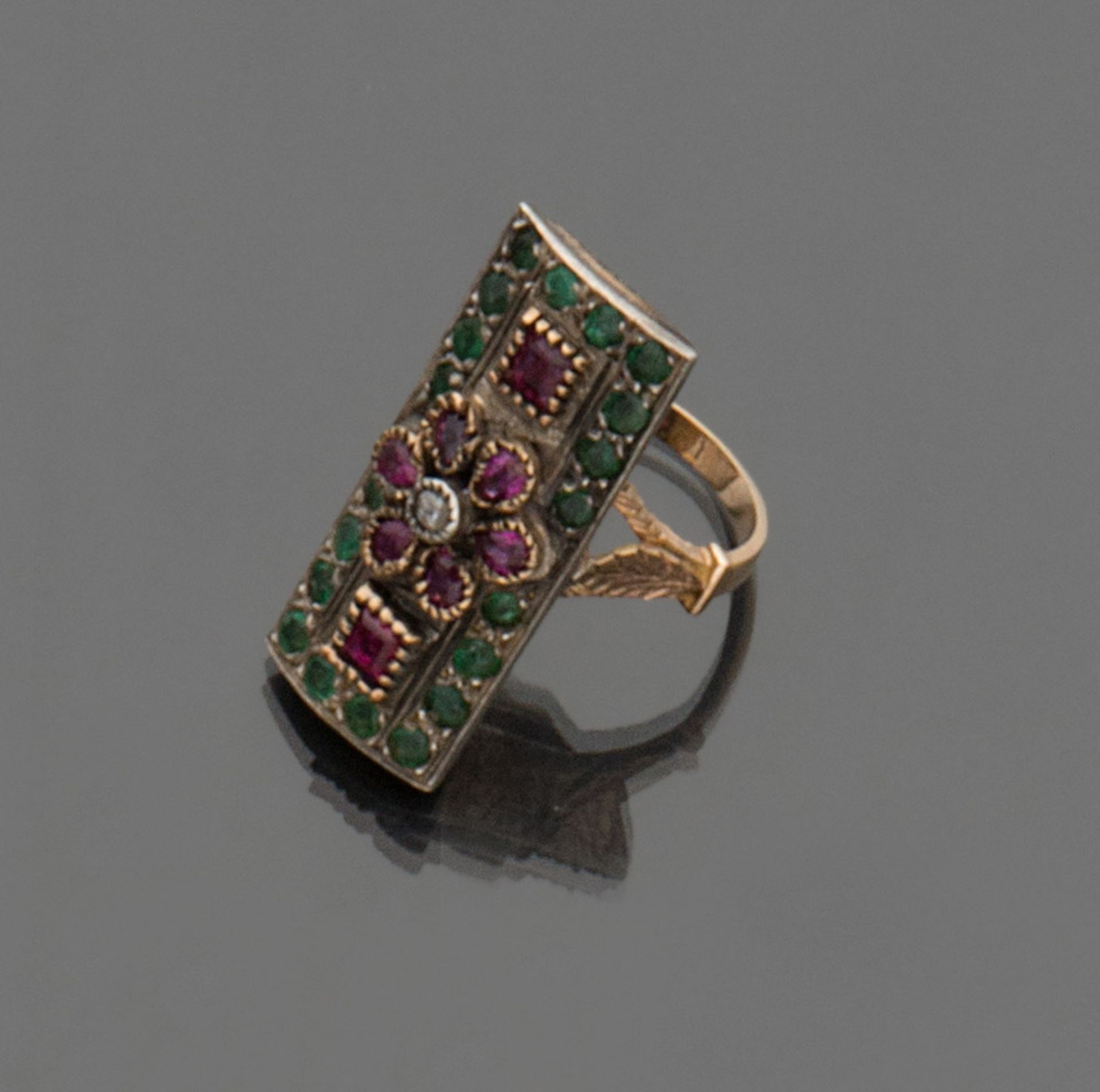 RING in yellow gold 18 kt. and silver, with a rectangular shape with rubies and emeralds embedded.