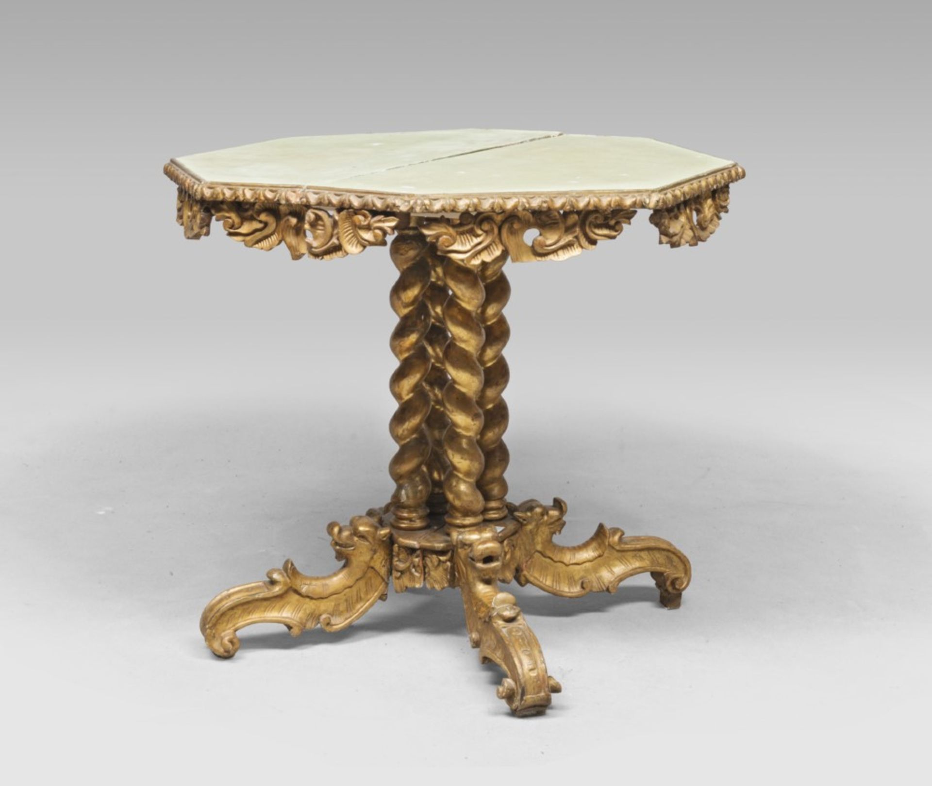 GILTWOOD TABLE, PROBABLY 19TH CENTURY with green lacquered octagonal top. Carved leaf and roccailles