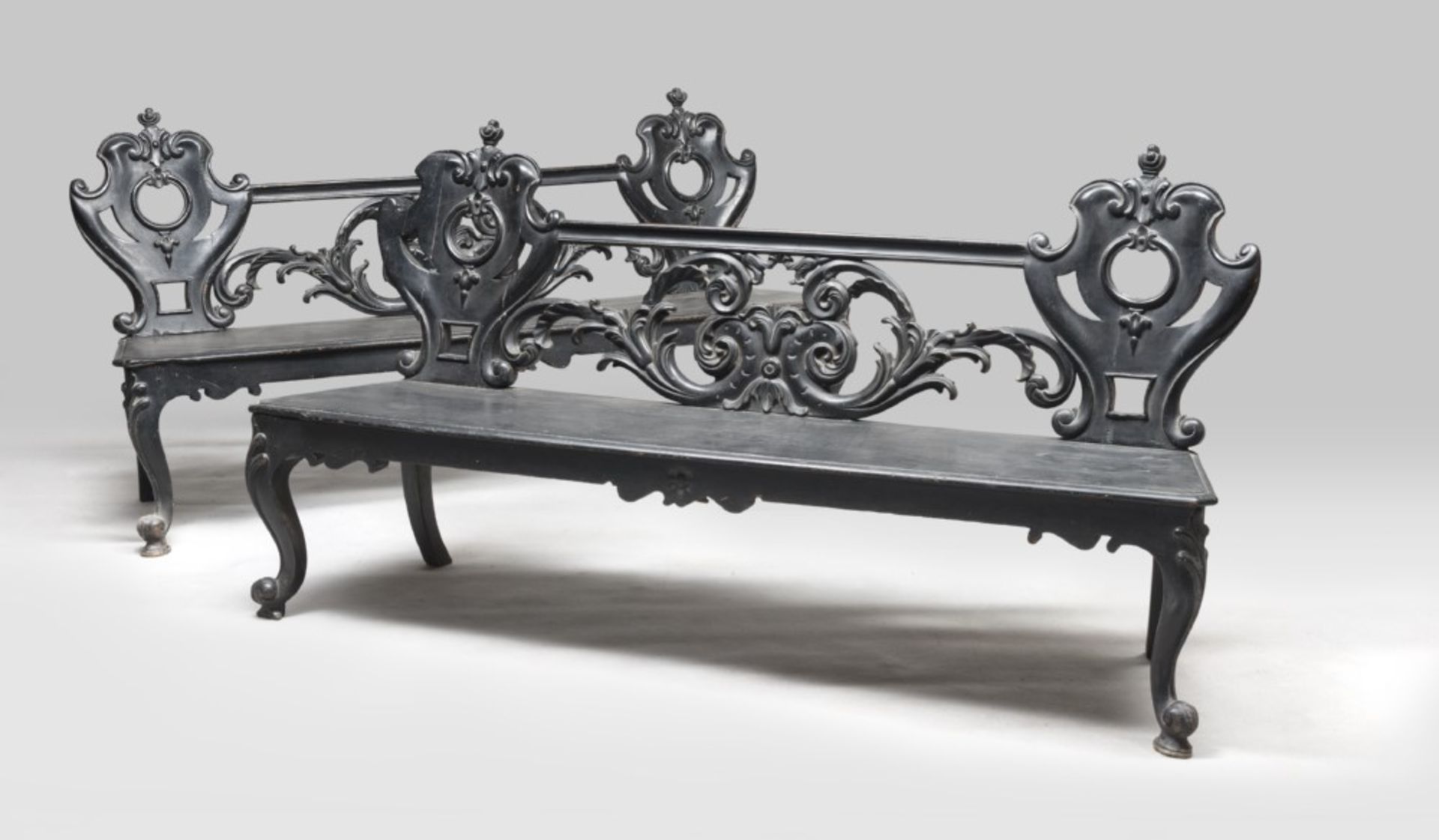 PAIR OF EBONY BENCHES, EMILIA OR FRANCE 19TH CENTURY with perforated back panels and carved by