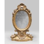 Gilded wooden Table-mirror, Rome 18th century Oval frame from carvings, roccailles and flowers.