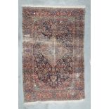 KIRMAN CARPET, EARLY 20TH CENTURY with central medallion and secondary reasons in flowers and a blue