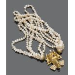 TORCEON GIROCOLLO five strands of keshi pearls, with 18 kt yellow gold clasp. a mask of Indian