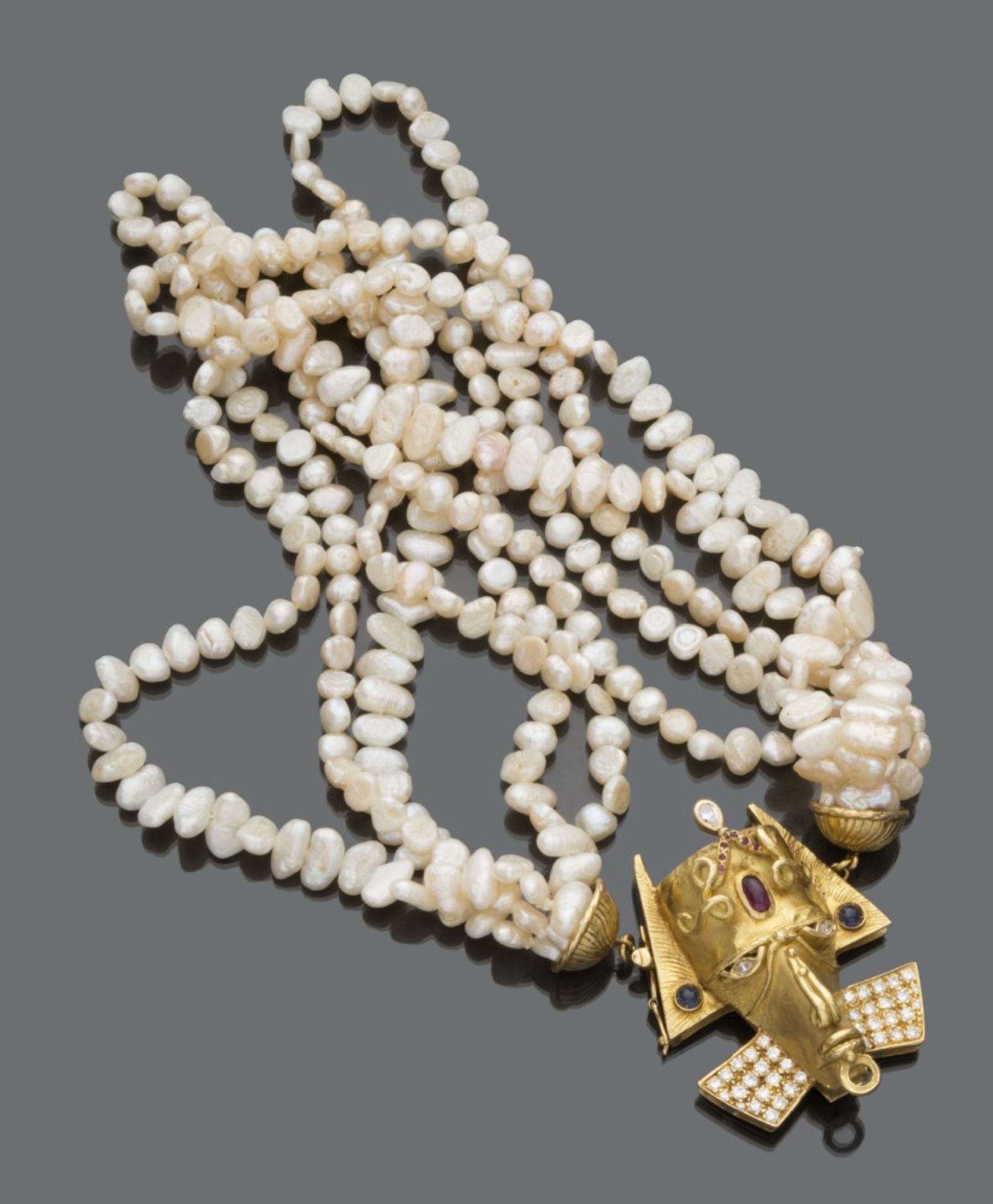 TORCEON GIROCOLLO five strands of keshi pearls, with 18 kt yellow gold clasp. a mask of Indian