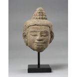 A Kmer carved sandstone Buddha's head. Cambodia, 12th - 13th century. Measures cm. 21 x 14 x 12.