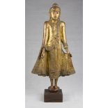 A Burma red and gold laquer wood sculpture, depicting Buddha. Early 20th century. Measures cm. 83