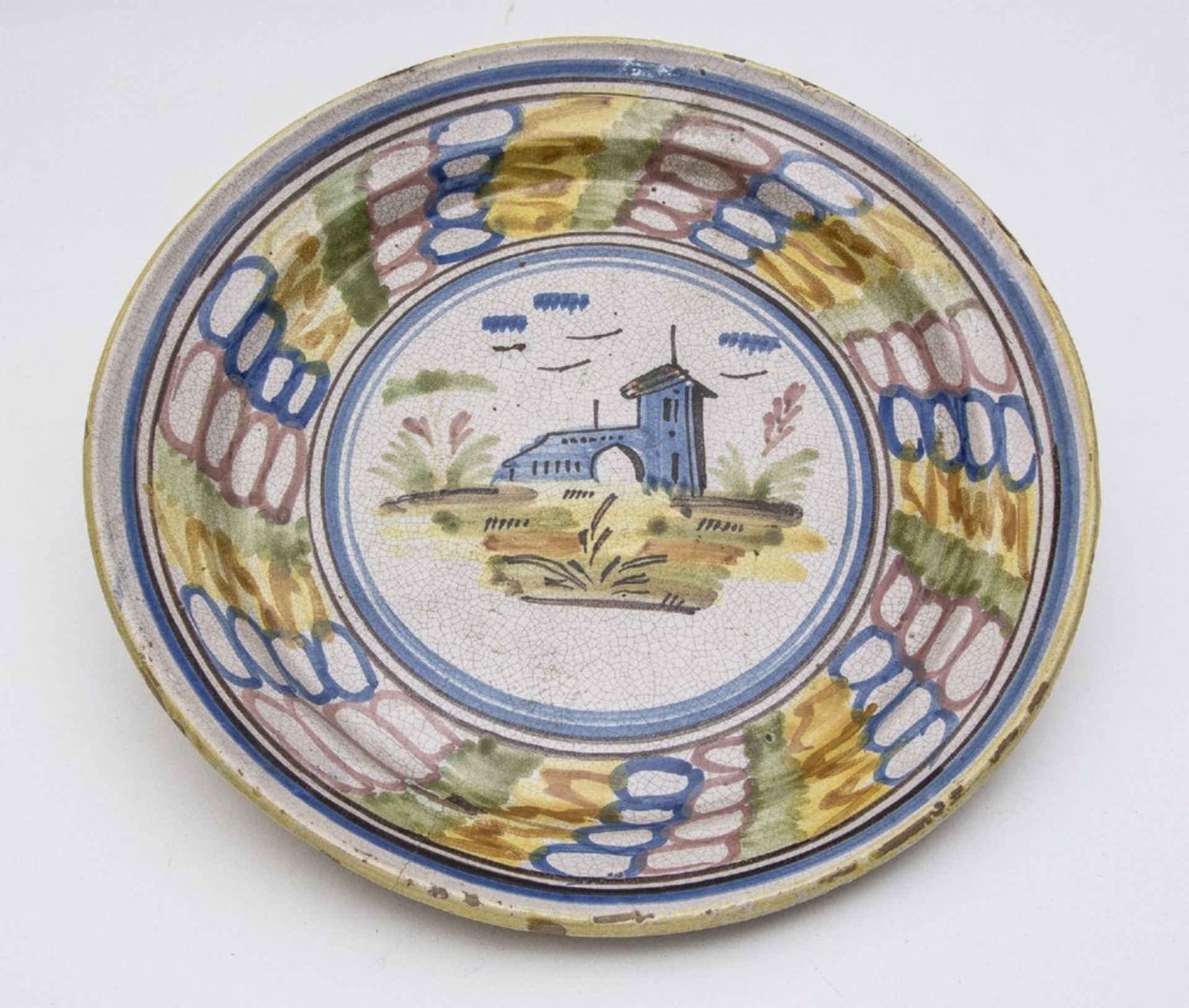 LARGE CERAMIC DISH, SOUTH ITALY 19TH CENTURY with decoration of a landscape with a castle. Roof