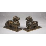 A pair of Chinese wood sculpture, depicting Buddhist lions. 20th century. Measures cm. 23,5 x 33 x