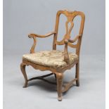 WOODEN ARMCHAIR, NORTH ITALY 18TH CENTURY with a perforated back and sculptured leaves on the hat.