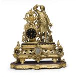 GILDED METAL TABLE-CLOCK, 19TH CENTURY in allegorical figure with a dog at the side of the dial.