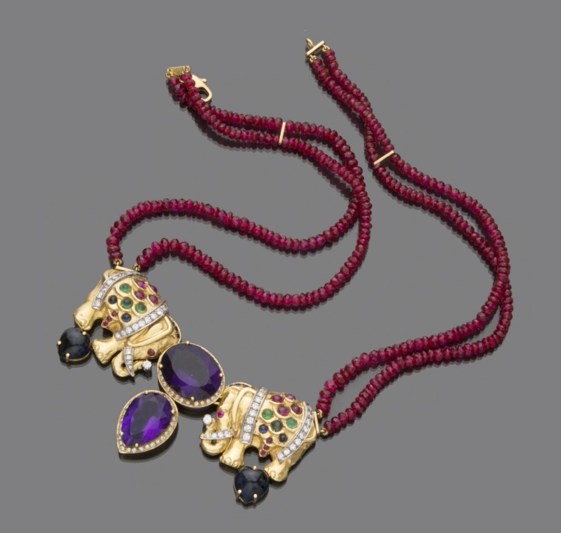 MORONI NECKLACE with two strands of ruby, with 18 kt yellow gold clasp, embellished with central