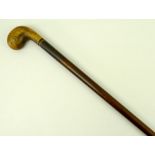 A rosewood, Sunday walking stick with rounded walnut putter handle with bone inlaid foot plate.