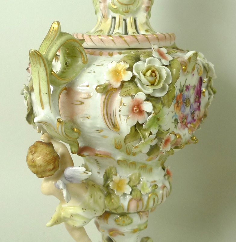 A pair of Sitzendorf lidded vases, decorated in high relief with flowers and pair of putti, - Image 4 of 8