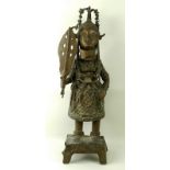 A bronze figure of an Ebu Oba holding a sword of state,