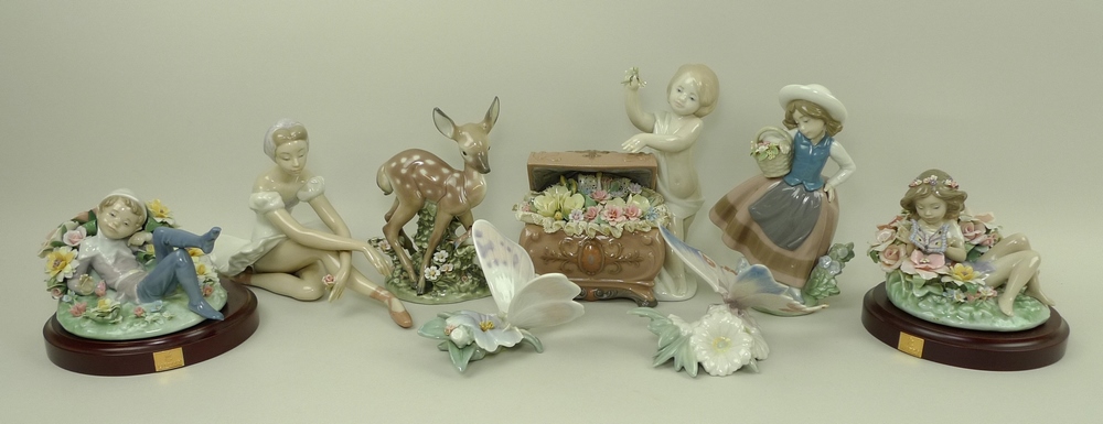 A group of Lladro porcelain figurines comprising a child and treasure chest of flowers,