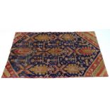 A well worn Hand knotted rug, 162 by 104cm.