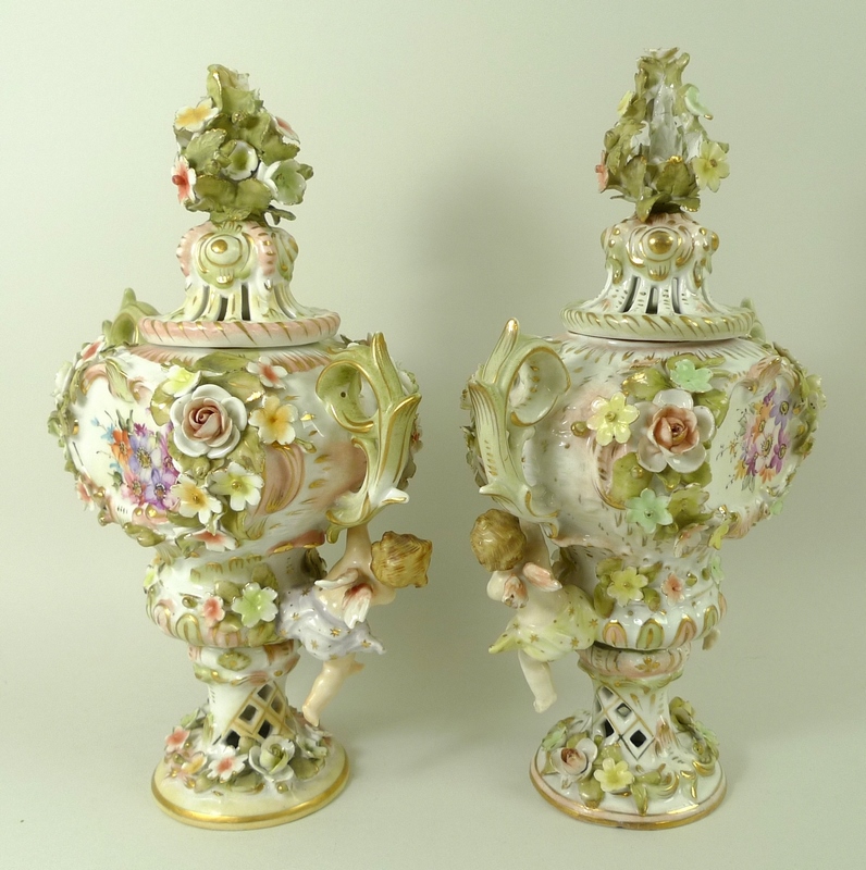 A pair of Sitzendorf lidded vases, decorated in high relief with flowers and pair of putti, - Image 6 of 8