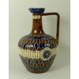 A Doulton Lambeth jug, the incised decoration depicting 'scales' and a 'beaded' belt, of ovoid form,