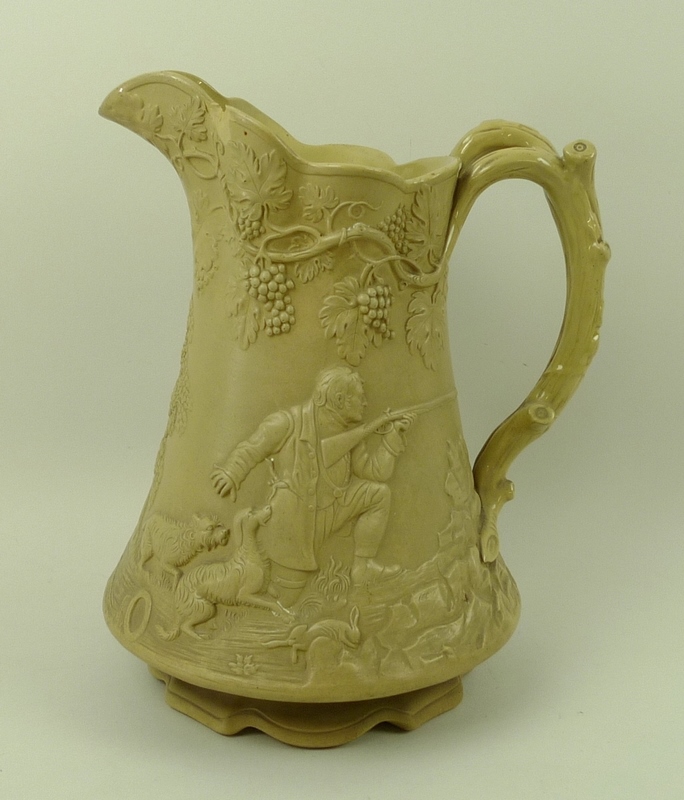 A Victorian stoneware pitcher jug, by Cobridge, cast in relief with a hunting,