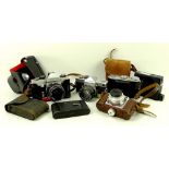 A group of vintage cameras and accessories, including a Leica viewfinder, in original box,